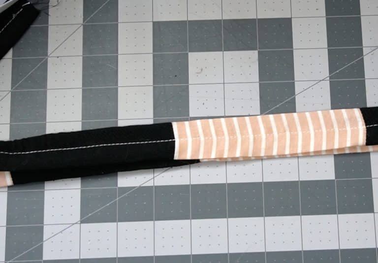 sew a seam down the center of the belt to form casings