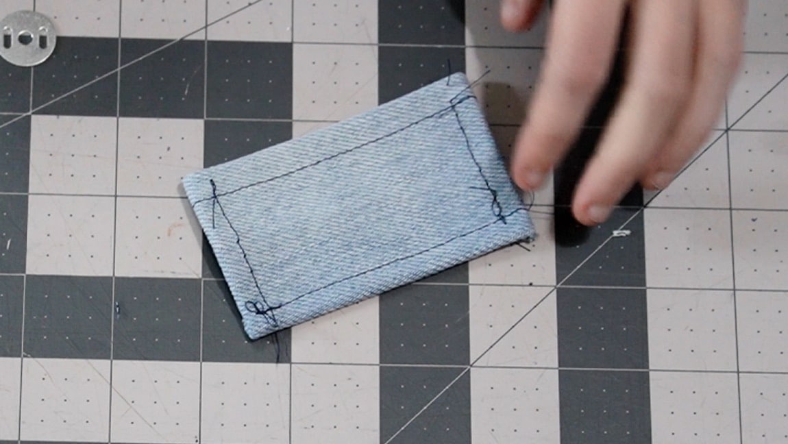 fold over the sides of the tab and baste in place