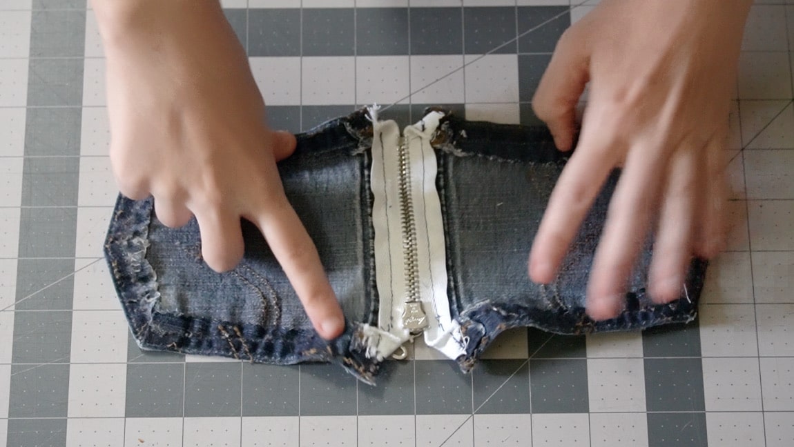 turn under edges of zipper