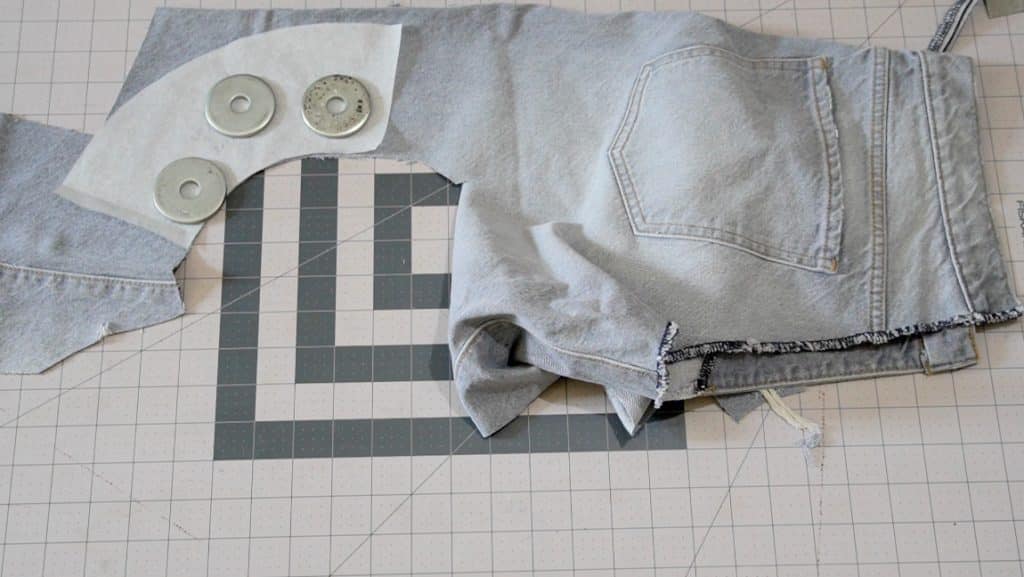 cutting out pattern pieces from old jeans