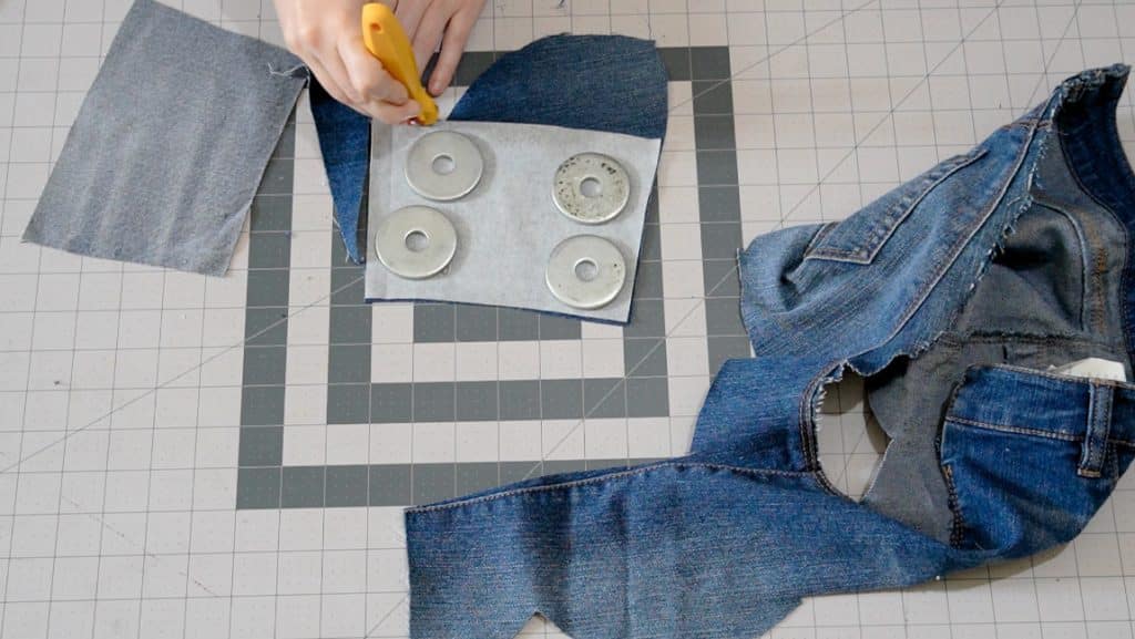 cutting out pattern pieces from old jeans