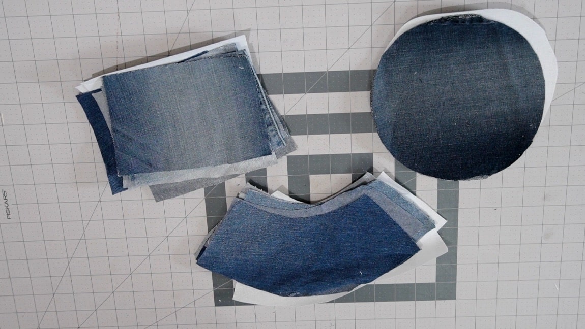 cutting out pattern pieces from old jeans