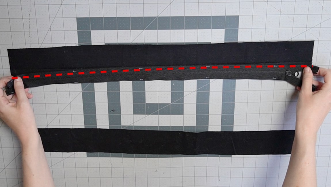 place the zipper face down in line with the edge of the overlap and sew through all layers