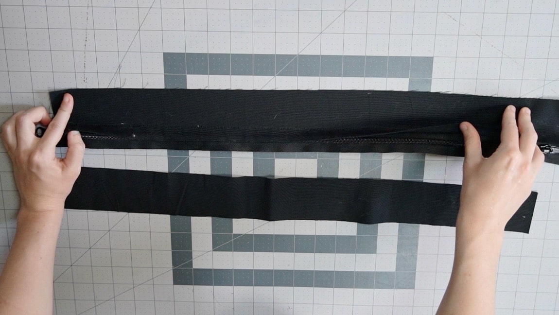 overlap goes over top of zipper