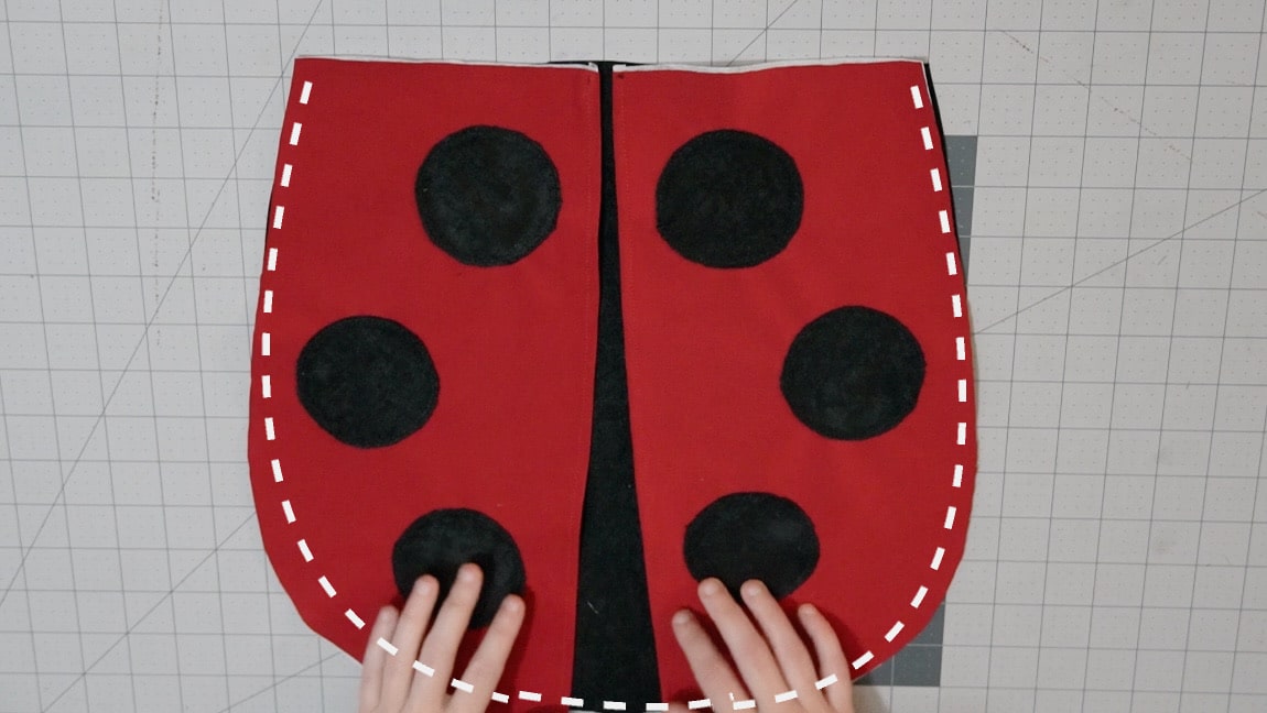 baste ladybug wings to one side of the bag