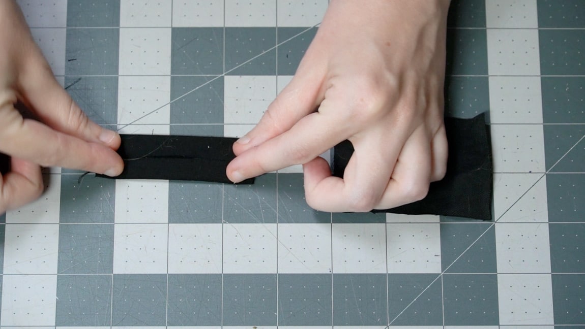 fold sides of tab to center