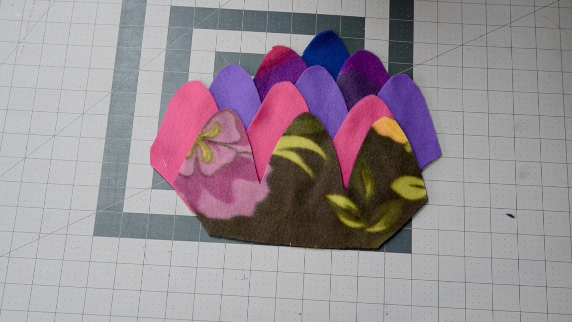 place next fleece piece 1 inch above, line up the other side diagonal