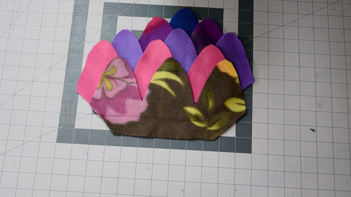place next fleece piece 1 inch above, line up the other side diagonal