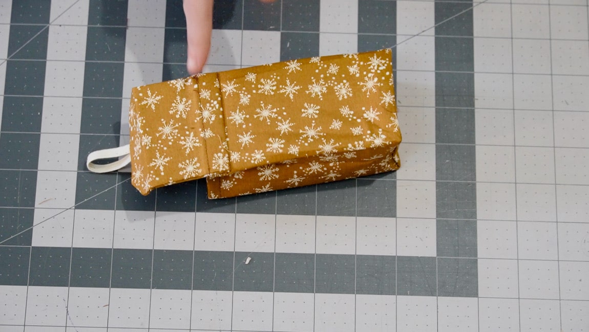 fold the top over the seam and sew close to the edge of the pouch