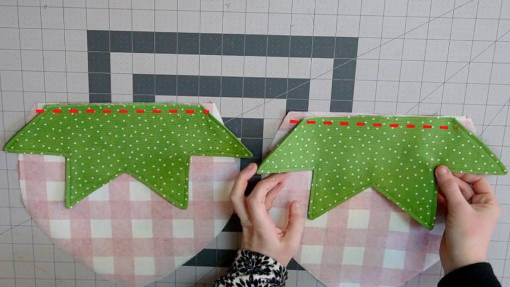 sew strawberry greens to the wrong side of strawberry purse