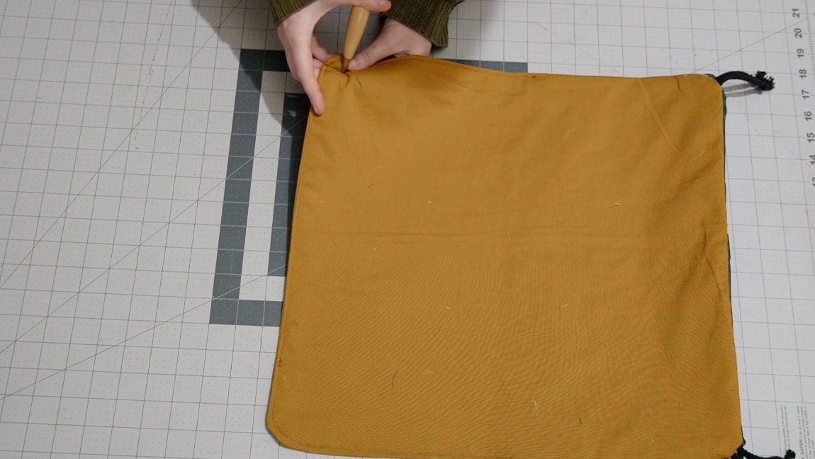 use an awl to poke a hole in both corners