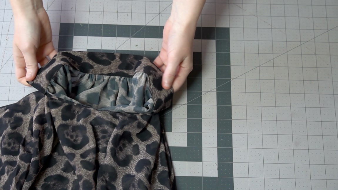 turn the neckband and fold the seam allowance under to sew in place