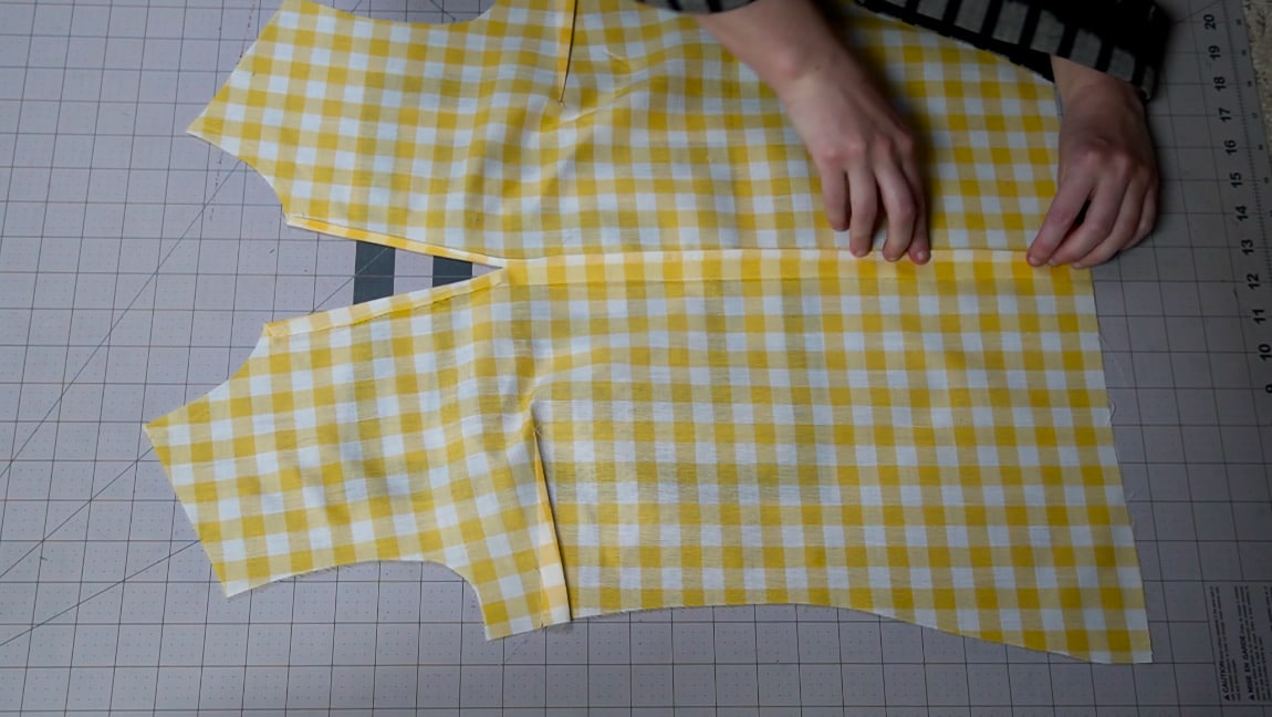 fold the seam allowance of the center front seam and hem the neckline